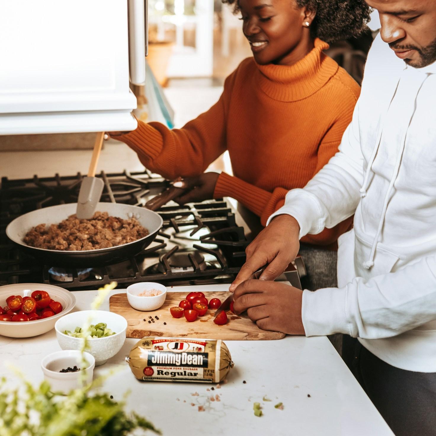 Participants collaborating in a contemporary kitchen, exchanging recipes and techniques